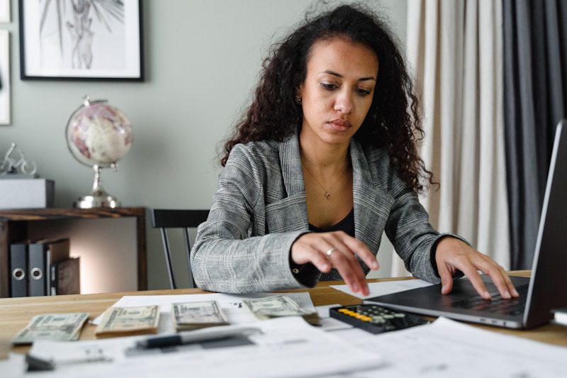 Woman balancing her finances at a computer