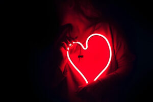 Person holding a neon heart