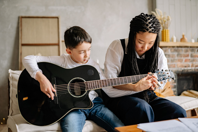 Caretaker and child with guitar
