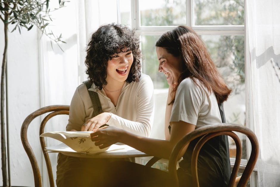 Two women at a table laughing