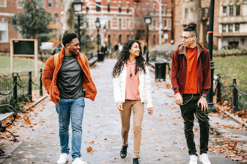 Three sober students walking on campus