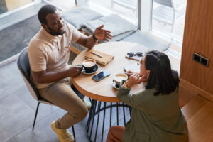 Man and woman at break room table with coffee