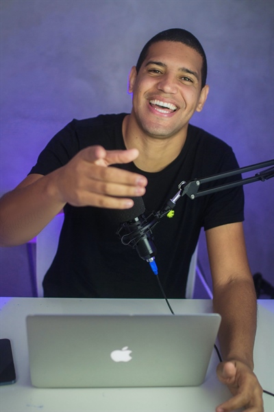 Man with a laptop doing a podcast