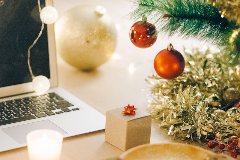 Laptop near a Christmas tree