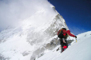Man climbing a mountain in the snow