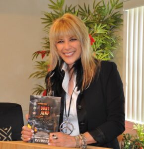 Vicki Abelson holding her book.